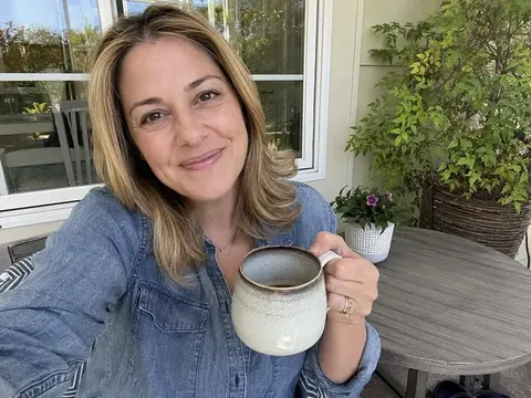 Marian F. holding a coffee mug